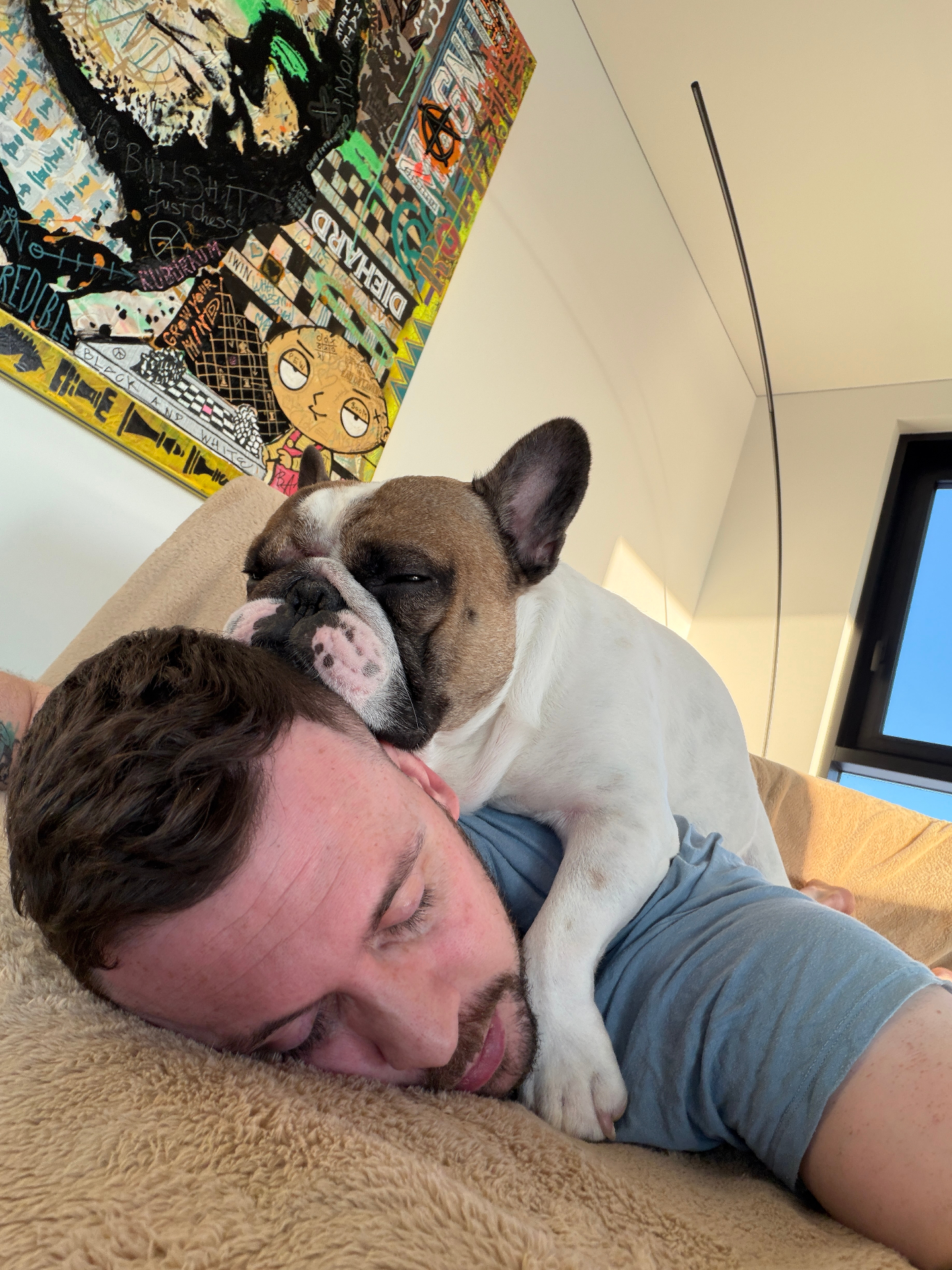 Daire and one of his dogs, curled up together